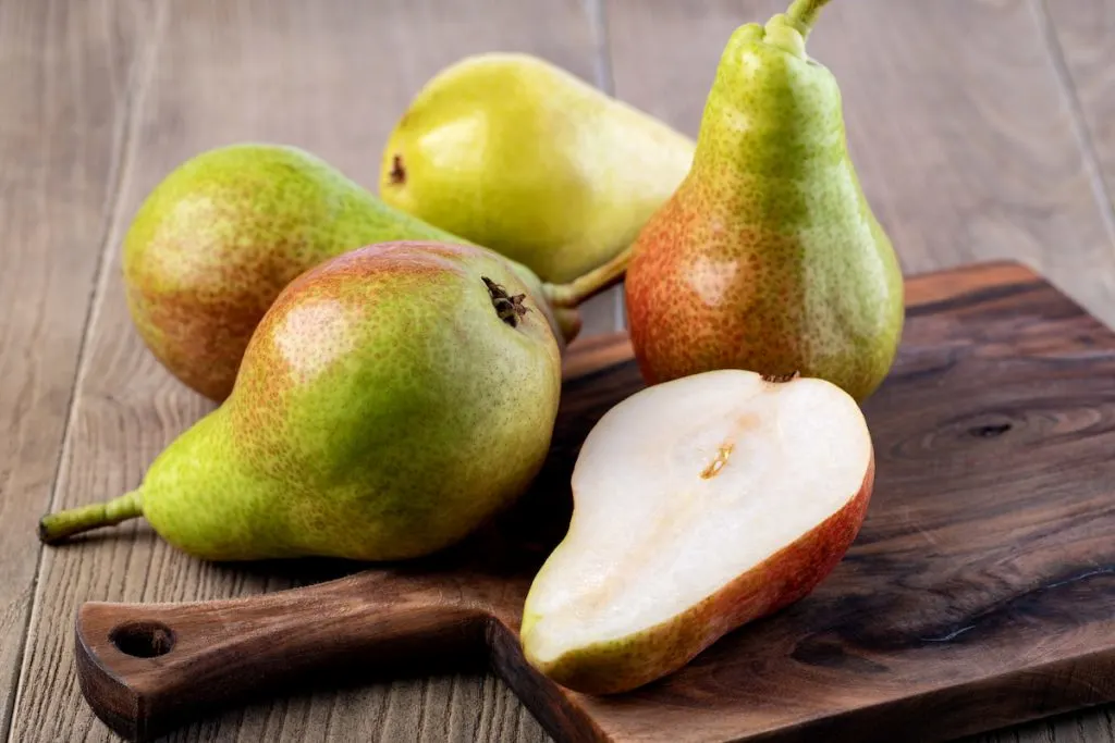 pears on wooden chopping board