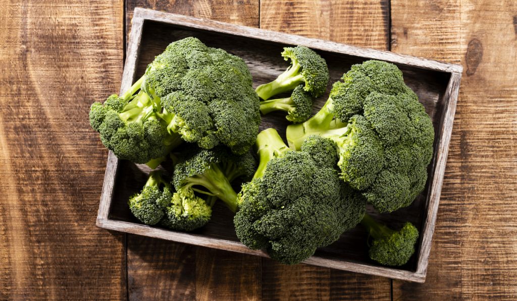 Fresh Broccoli slices on wooden tray