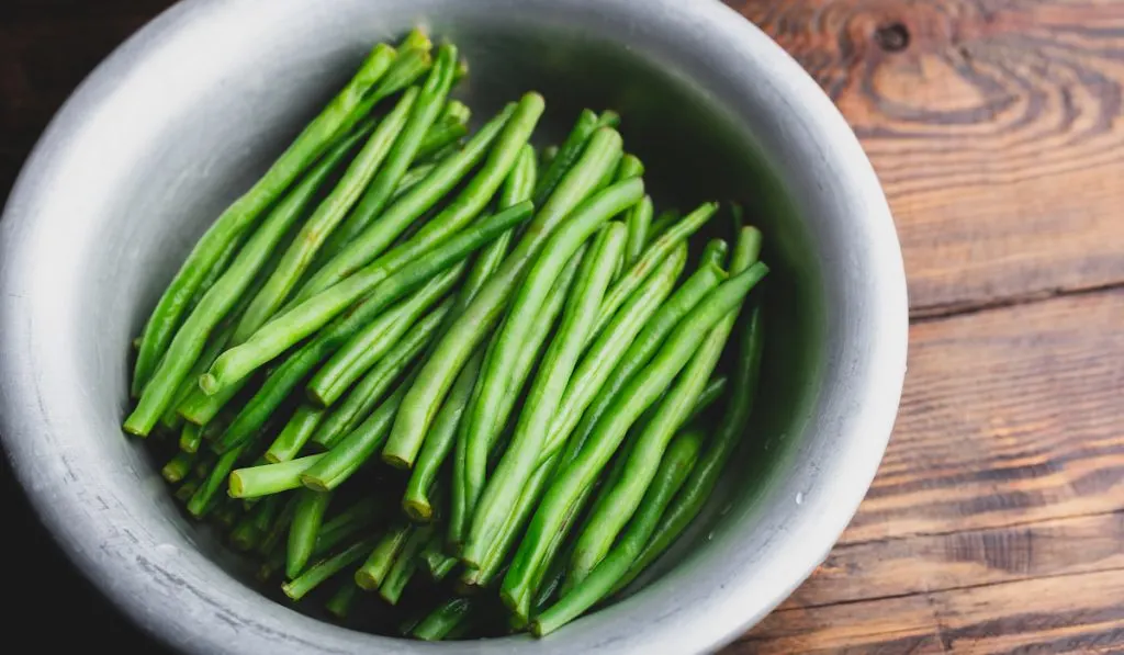 Green Bean in Bowl on wooden background 