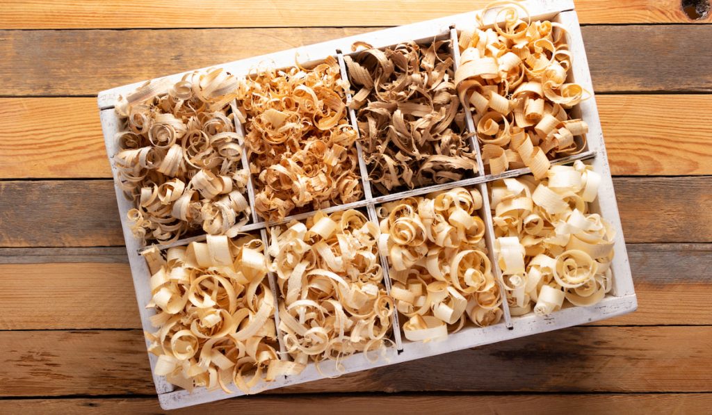 Wood shavings in box at table background 