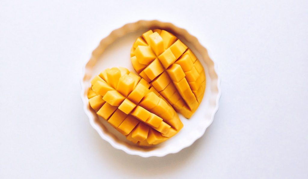 a pair of sliced mangoes