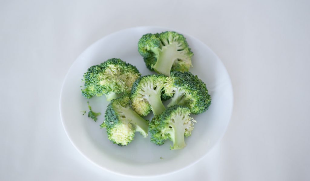 slices of broccoli on white plate 